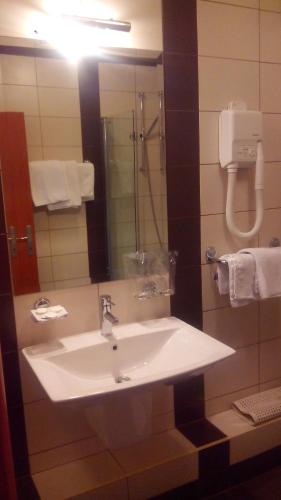 a bathroom with a white sink and a mirror at Hotel Kutina in Kutina