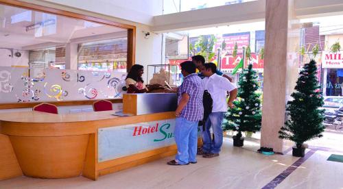 a group of people standing at a counter in a store at Hotel Susee Park in Tiruchchirāppalli