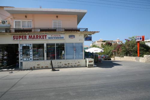 a store on the side of a street at Hotel Kathrin Beach in Adelianos Kampos