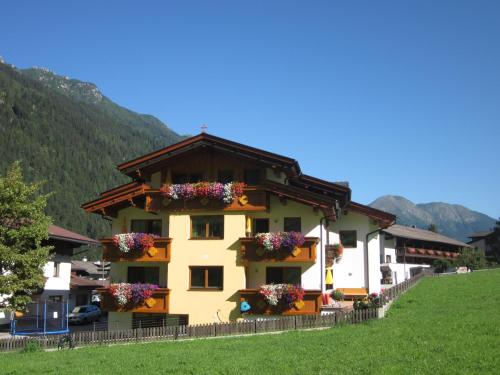 a building with flower boxes on the side of it at Haus Rosmarie in Neustift im Stubaital