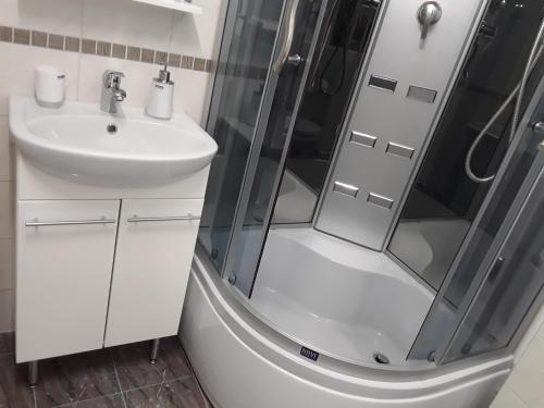 a bathroom with a shower and a sink at VBE apartments in Narva