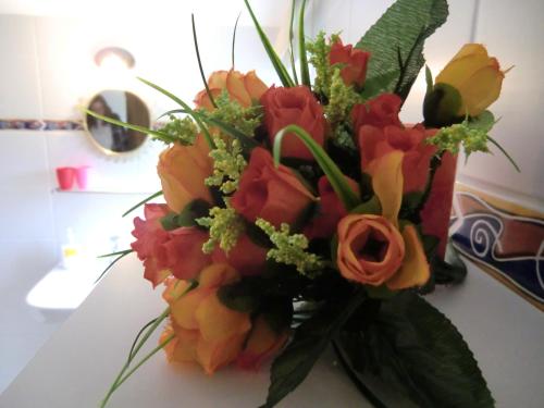a bouquet of flowers sitting on a table at B&B Au Coeur de Villers in Villers-Sainte-Gertrude