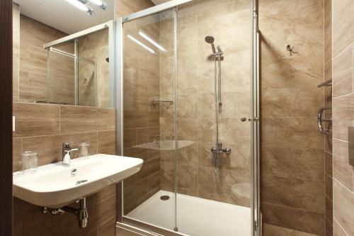 a bathroom with a sink and a shower at Old Town Trio Apartments in Vilnius