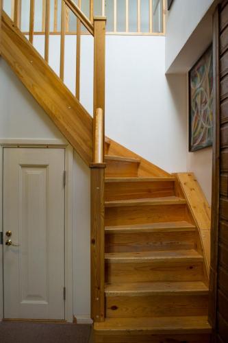 a wooden staircase in a house with a door at Tampere Maja in Tartu
