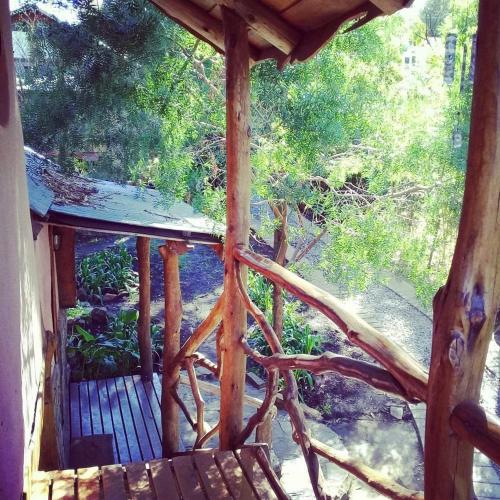 an outside view of a wooden porch with a bench at Cabañas Las Moras in Tandil