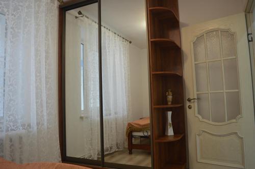 a large mirror in a room with a window at Dream House in Bălţi