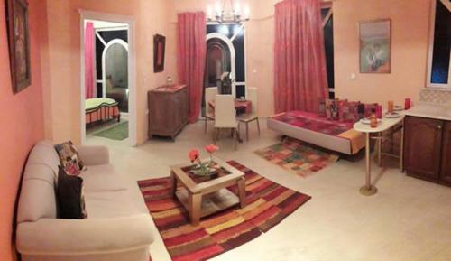 a living room with a couch and a table at Semiramis Apartments in Ierapetra