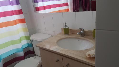 a bathroom with a sink and a toilet at Departamento Papudo Laguna 120 in Papudo