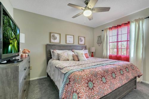 a bedroom with a bed and a flat screen tv at Disney Themed Family Villa, Waterpark & Resort Amenities Included in Kissimmee