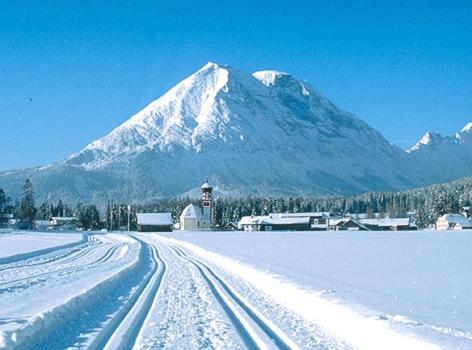 a snow covered mountain with a snow covered road at Hotel Hochland in Leutasch