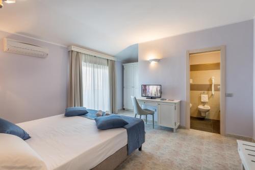 Postel nebo postele na pokoji v ubytování Hotel Rosa dei Venti