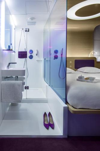 - une chambre avec un lit, un lavabo et des chaussures dans l'établissement Hôtel Odyssey, à Paris
