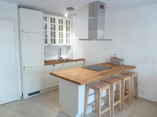 une cuisine avec des armoires blanches et un comptoir en bois dans l'établissement Elegant two bedroom apartment with modern design and terrace close to beaches and Cannes center 546, à Cannes