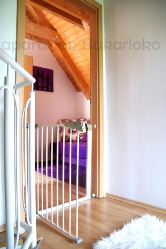 a view from the hallway of a room with a balcony at Bakarloko Lipno Apartments in Lipno nad Vltavou