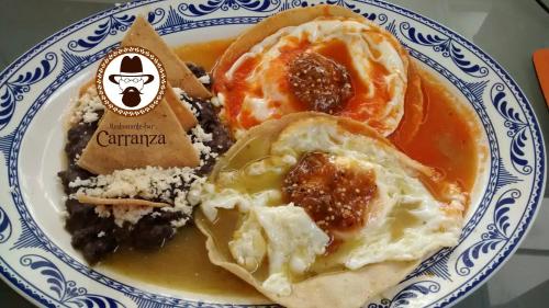 a blue and white plate of food with eggs and rice at Hotel Casablanca Xicotepec in Xicotepec de Juárez