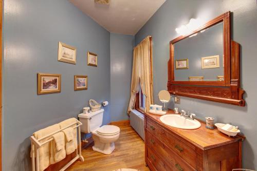 a bathroom with a sink and a toilet and a mirror at Margaretville Mountain Inn B&B in Margaretville