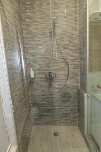 a bathroom with a shower with a glass door at Apartments Parlament in Belgrade