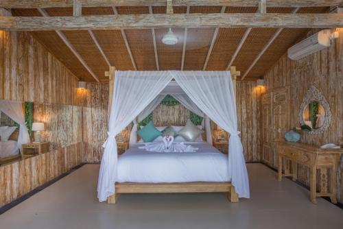 a bedroom with a bed with a canopy at Bella Kita Mountain Retreat & Spa in Klungkung