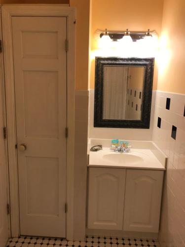 a bathroom with a sink and a mirror at Elaine's Cape May Boutique Hotel in Cape May