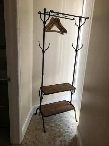 a wooden shelf in the corner of a room at Elaine's Cape May Boutique Hotel in Cape May