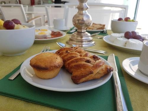 a table with a plate of food with a pastry on it at La Dimora delle Fate Luxury & SPA in Miggiano