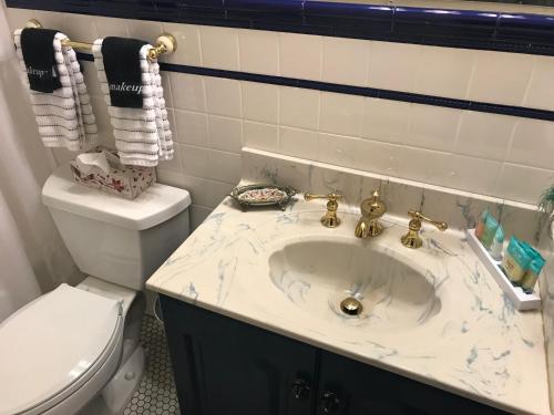 a bathroom with a sink and a toilet at Elaine's Cape May Boutique Hotel in Cape May