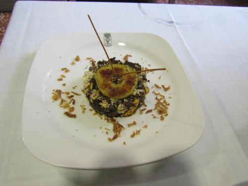 a white plate with a dessert on a table at Hospederia del Real Monasterio in Guadalupe