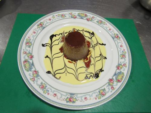 a plate with a chocolate dessert on a green table at Hospederia del Real Monasterio in Guadalupe