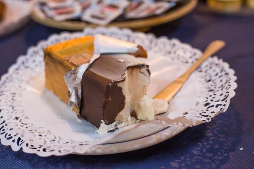 a piece of chocolate cake on a plate with a fork at Hotel Ristorante La Perla in Varallo Pombia