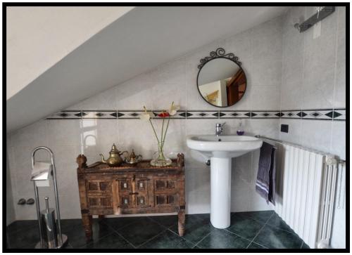a bathroom with a sink and a mirror at WAOBAB - We are one B&B in Alzano Lombardo