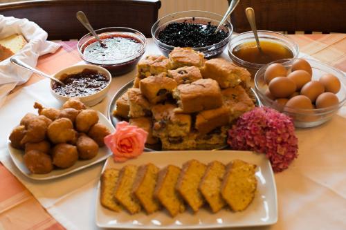 a table topped with plates of food on a table at Mirtillo Apartments in Kissós