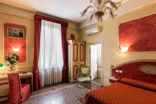 a bedroom with a bed and a chair and a window at Antica Residenza D'Azeglio Room&Breakfast di Charme in Bologna