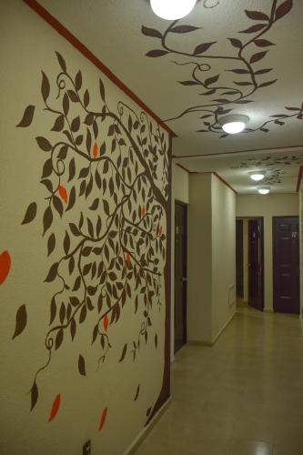 a hallway with a tree mural on the wall at Suites Los Arcos in Isla Mujeres