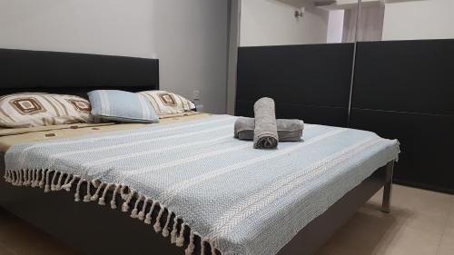 a bedroom with a large bed with towels on it at Spinola Seafront Apartment in St. Julianʼs