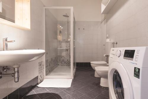 a bathroom with a washing machine and a sink at Saragozza Apartments - Bologna Short Rental in Bologna