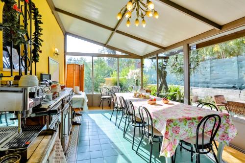 a kitchen with a table and chairs in a room at Cà De Rossana Bed&Breakfast in Sanremo