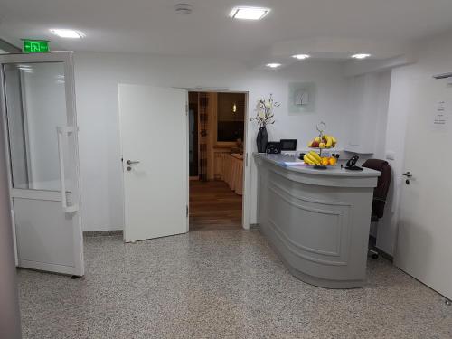 a kitchen with a counter in the middle of a room at Hotel Soad in Salach