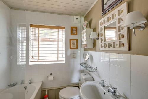 a bathroom with a sink and a toilet and a tub at Aberdaron Cottage 2 Bryn Chwilog in Aberdaron