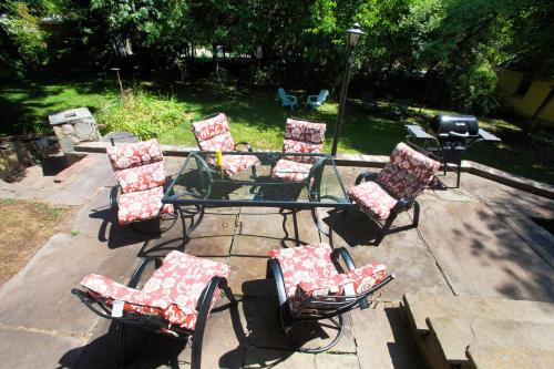 a group of chairs and a table with a grill at Village Suites in Margaretville