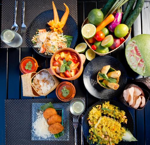 a table with plates of food and bowls of vegetables at Radisson Blu Resort Fiji in Denarau