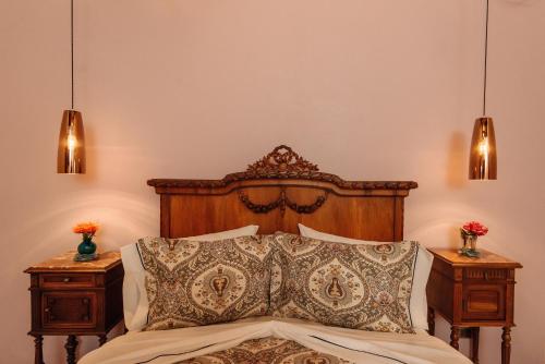 a bedroom with a wooden bed with two night stands at Hotel Marqués del Ángel in Puebla