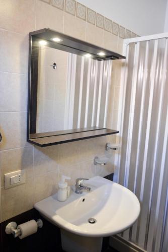 a bathroom with a white sink and a mirror at Antica Vittoria in Vittoria
