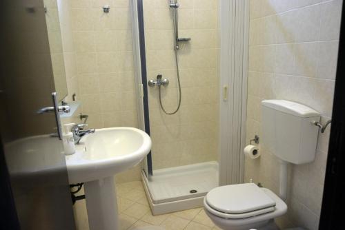 a bathroom with a shower and a toilet and a sink at Antica Vittoria in Vittoria