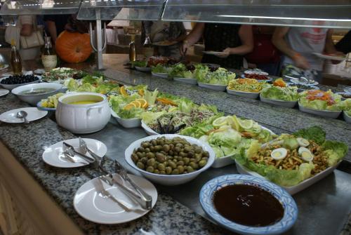 a buffet with many bowls of food on a counter at El Mouradi El Menzah in Hammamet