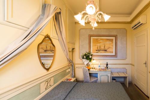 a bedroom with a bed and a mirror and a table at Antica Residenza D'Azeglio Room&Breakfast di Charme in Bologna