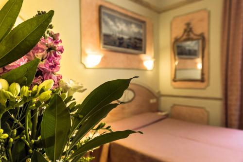 a dining room with a table and flowers at Antica Residenza D'Azeglio Room&Breakfast di Charme in Bologna