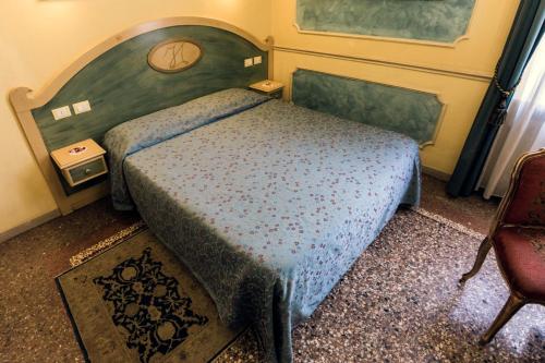 a bedroom with a bed with a wooden head board at Antica Residenza D'Azeglio Room&Breakfast di Charme in Bologna