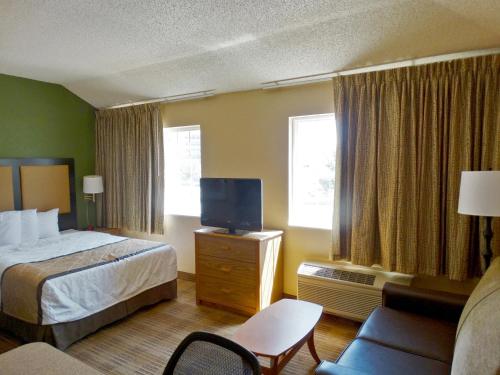 a hotel room with a bed and a tv at Extended Stay America Suites - Boston - Peabody in Peabody