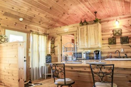 a kitchen with wooden walls and a wooden ceiling at City on a Hill at Spring Creek in Fredericksburg