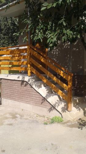 a wooden bench sitting on the side of a building at Центрові апартаменти in Ivano-Frankivsʼk